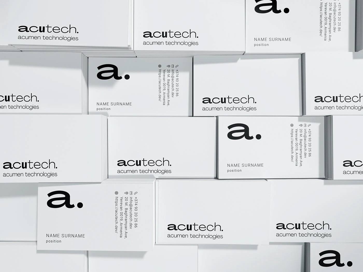 ACUTECH business cards arranged in a precise monochrome grid
