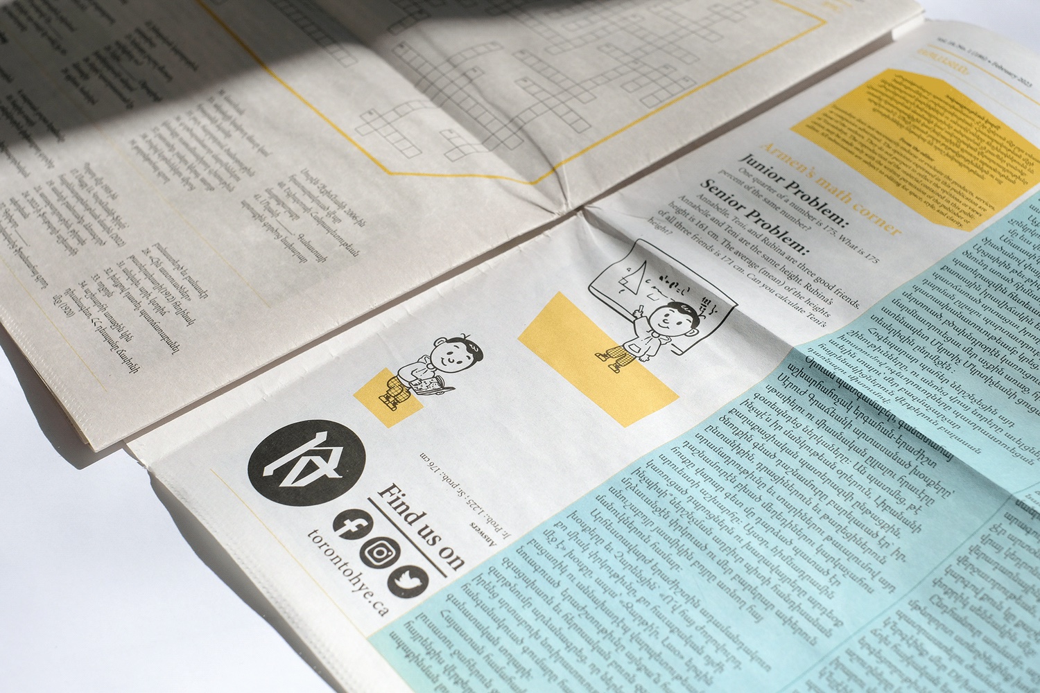 Published Torontohye newspaper spread showing multilingual editorial design and illustrated puzzle content